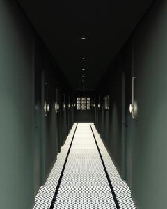 a dark hallway with a light at the end at DoubleTree by Hilton Madrid Principe de Vergara in Madrid +4 photos