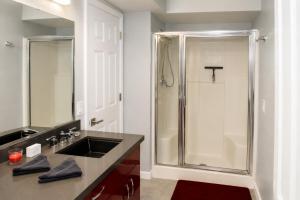 a bathroom with a shower with a sink and a counter at RIVERFRONT RUBY RED HOME WITH PRIVATE DOCK & View in Bullhead City +26 photos