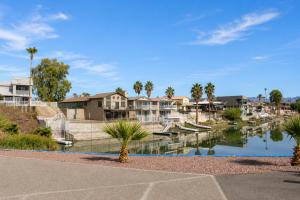 a view of a river with houses and boats at RIVERFRONT RUBY RED HOME WITH PRIVATE DOCK & View in Bullhead City