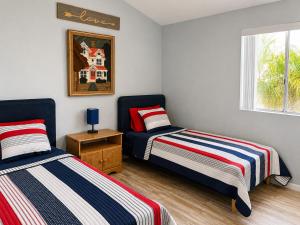 a bedroom with two beds and a window at RIVERFRONT RUBY RED HOME WITH PRIVATE DOCK & View in Bullhead City