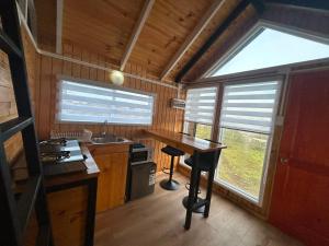 a kitchen with a table and a sink and a window at Dyl Tiny House con Jacuzzi in Puerto Montt