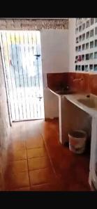 a room with a door and a table and a window at Wana Soeiro in Marapanim