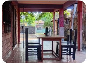 a wooden table and chairs in a patio at Wana Soeiro in Marapanim