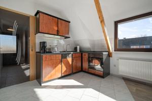 a kitchen with a stove and an oven at Ferienwohnung-mit-Balkon in Rechlin