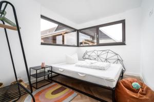 a bedroom with a bed and two windows at Ferienwohnung-Cleo in Mirow