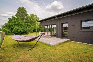 a hammock in the yard of a house at Ferienwohnung-Cleo in Mirow