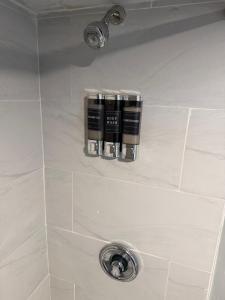 a shelf in a shower with three bottles on it at 50 Private Lounge in Irvington +13 photos