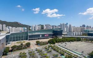 a city with a building and a parking lot at BS Centum hotel in Busan