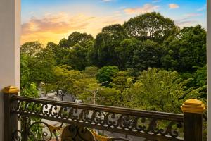 a balcony with a view of a forest of trees at Yoyo Airport Saigon Hotel in Ho Chi Minh City