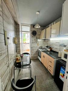 a small kitchen with a chair and a table in it at Departamento chic centro 2 habitaciones in Mendoza