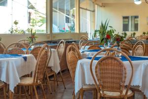 a row of tables and chairs in a restaurant at Pousada Bela Vista in Conde