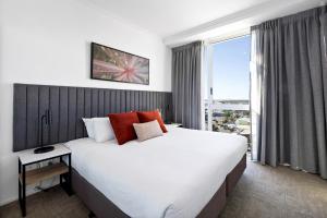 a bedroom with a large bed and a large window at Quest Mackay on Gordon in Mackay +29 photos
