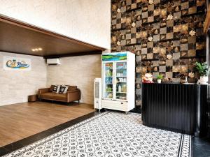 a room with a refrigerator and a couch in it at Khách Sạn Cát House in Ha Long