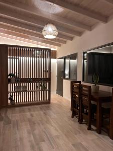 a dining room with a table and chairs and a ceiling at Monteolivos Home & Suites in El Rincón