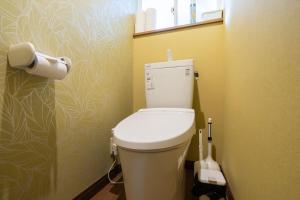 a bathroom with a toilet with a roll of toilet paper at S-villa Nasu 4th in Nasu +60 photos