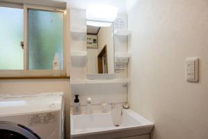 a bathroom with a sink and a mirror at S-villa Nasu 4th in Nasu