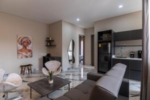 a living room with a couch and a kitchen at Hotel Colores Estadio in Medellín