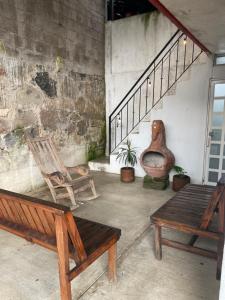 a room with two wooden benches and a staircase at Arca de Noé in Xaltepec