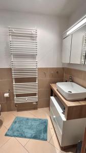 a bathroom with a sink and a toilet and a mirror at Kunst-kuesst-Kueste in Hohwacht +23 photos