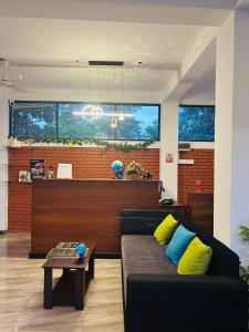 a living room with a couch and a table at Unic Residence And Transit Hotel in Katunayaka