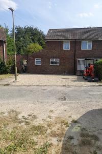 a brick house with a tractor parked in front of it at Greenview in Didcot