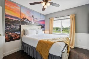 a bedroom with a bed with a painting on the wall at Country Style Home 4br 2bth in Brewer