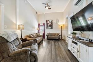 a living room with a couch and a flat screen tv at Country Style Home 4br 2bth in Brewer