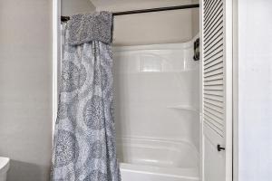 a shower with a shower curtain in a bathroom at Country Style Home 4br 2bth in Brewer +23 photos