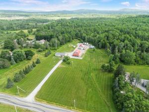 an aerial view of a large field with a house at Country Style Home 4br 2bth in Brewer