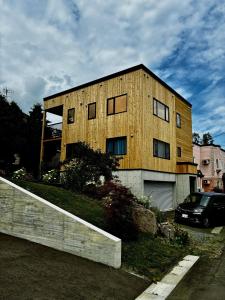 a building with a car parked in front of it at The Box House in Furano