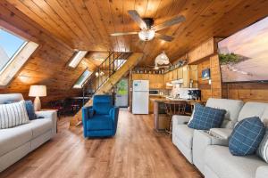 a living room with two couches and a ceiling fan at Chalet #57 in Stevensville