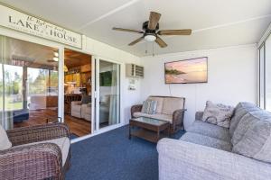 a living room with two couches and a ceiling fan at Chalet #57 in Stevensville