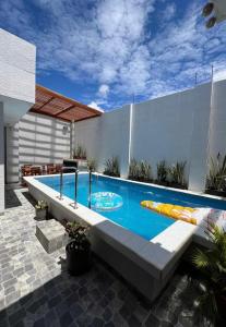 a swimming pool in the backyard of a house at Mihahi Beach Mancora in Máncora