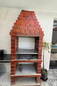 an outdoor brick oven with steps in a patio at Mihahi Beach Mancora in Máncora