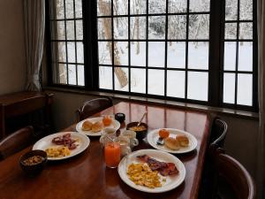 a table with plates of breakfast food on it at Daiju Myoko - Renovated in 2025 in Myoko