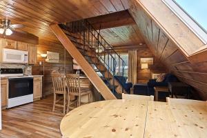 a kitchen and dining room with a wooden ceiling at Chalet #44 in Stevensville +35 photos