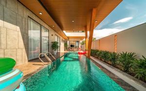 a swimming pool in the middle of a house at Cloud Rose Villa Hoi An in Danang