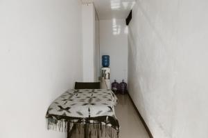 a narrow hallway with a table in a white room at PELICAN TOURS in Puerto Baquerizo Moreno +22 photos