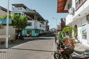 a motorcycle parked on the side of a street at PELICAN TOURS in Puerto Baquerizo Moreno