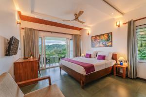 a bedroom with a bed and a balcony at Falcon Crest in Vagamon +91 photos