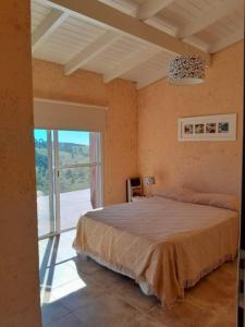 a bedroom with a bed and a large window at Iorana in Villa Berna