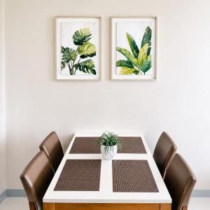 a dining room table with a potted plant on it at The Mactan Beach Condo Staycation in Punta Engaño