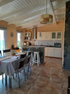 a kitchen with a table and chairs in a room at Iorana in Villa Berna
