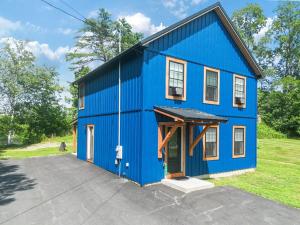 a blue house with a garage at New Riverside Fire Pit 3BR 2.5 bath in Brewer