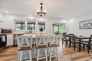 a kitchen and dining room with a table and chairs at New Riverside Fire Pit 3BR 2.5 bath in Brewer