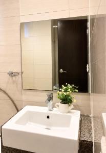 a bathroom with a white sink and a mirror at The Mactan Beach Condo Staycation in Punta Engaño