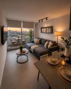 a living room with a couch and a table at Nómade Summer Home in Iquique