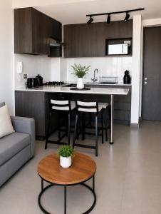 a kitchen and living room with a table and a couch at Nómade Summer Home in Iquique +6 photos