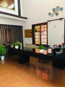 a desk in a room with potted plants on it at Phum Angkor in Siem Reap +35 photos