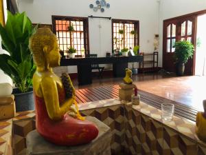 a statue of a woman sitting in the middle of a room at Phum Angkor in Siem Reap